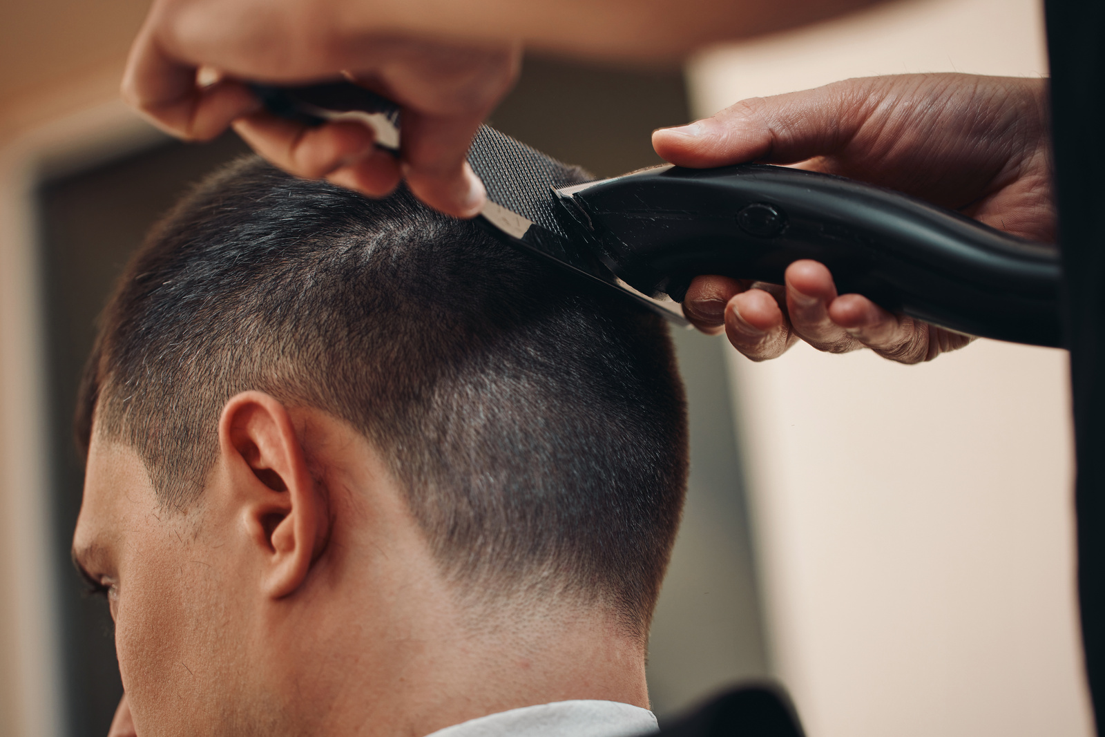 Barber Shaving Caucasian Man in Barber Shop